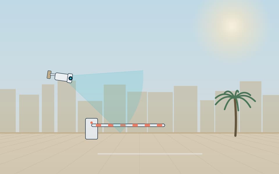 Vehicle barrier with an ANPR camera at a site entrance, in daylight