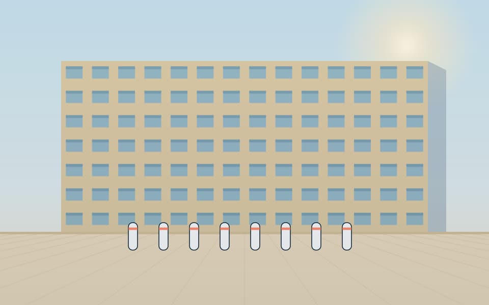 Anti-ram bollards in front of a building, in daylight
