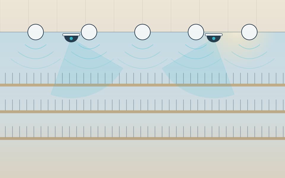 Mall atrium with cameras and ceiling speakers, in daylight